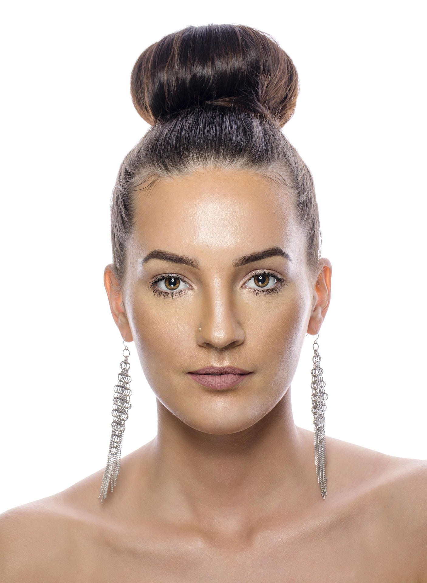 AEVUM huggie earrings styled in a curated ear stack on a Los Angeles fashion influencer
