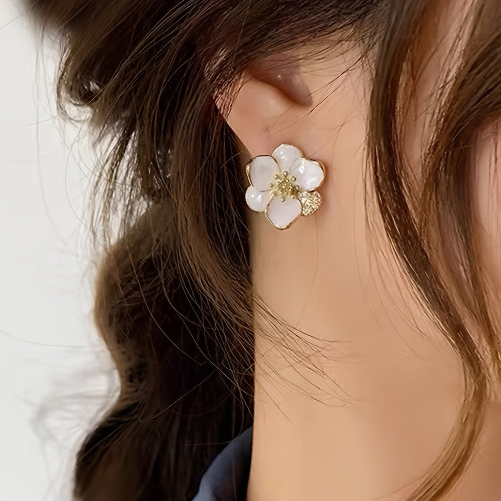 Woman wearing minimal gold hoop earrings — tarnish-free everyday jewelry trend 2026
