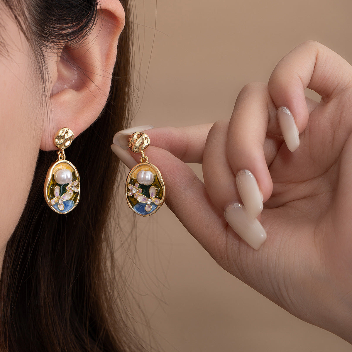 Monet Garden pearl earrings worn on ear, vintage oil painting style